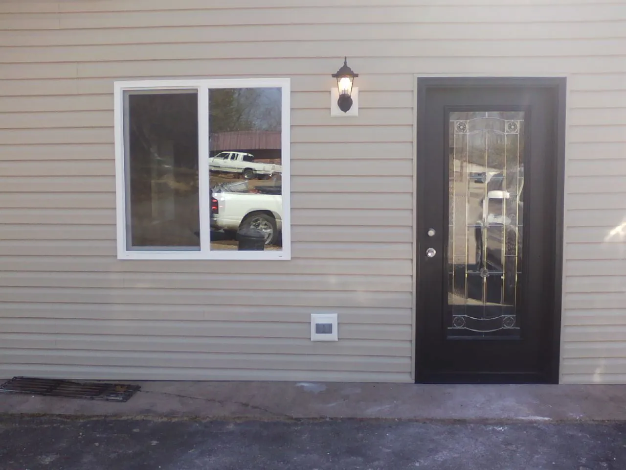 New siding, window and entry door on the side of an addition in New Melle